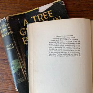 Log Cabin Vintage - vintage fiction, American Author, American novel - A Tree Grows in Brooklyn by Betty Smith - view of the book on a wood table showing the copyright page